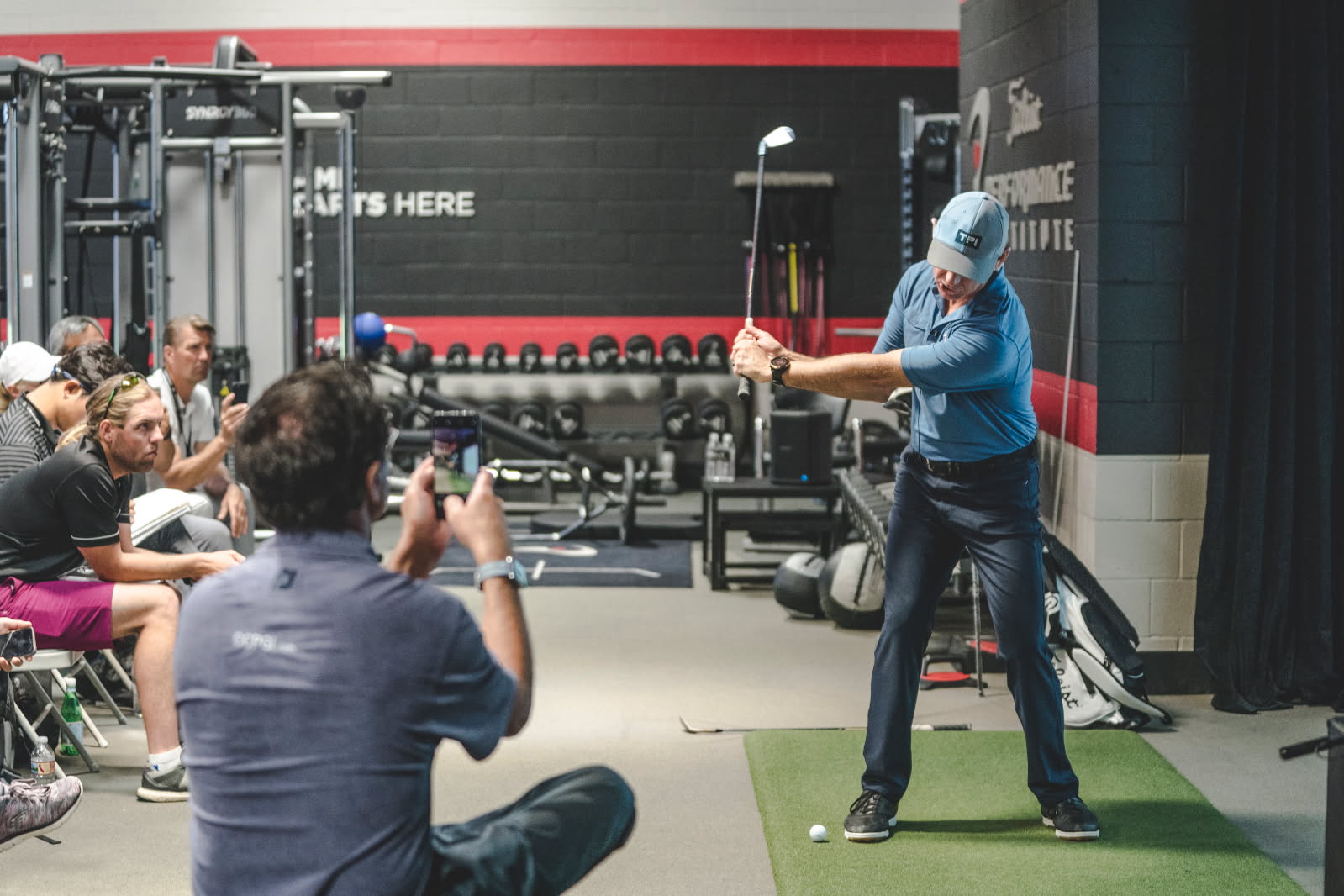 PGA instructor giving a one-on-one golf lesson
